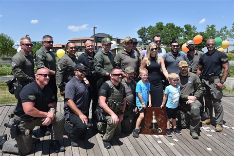 Group of Police Officers with a Make A Wish family